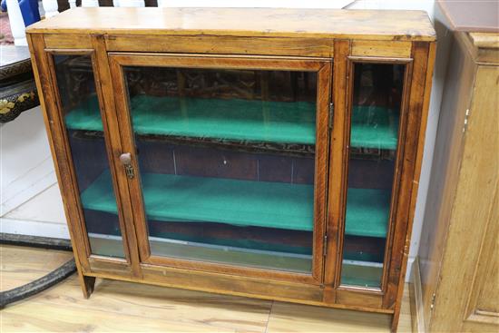 A pine glazed bookcase 104cm